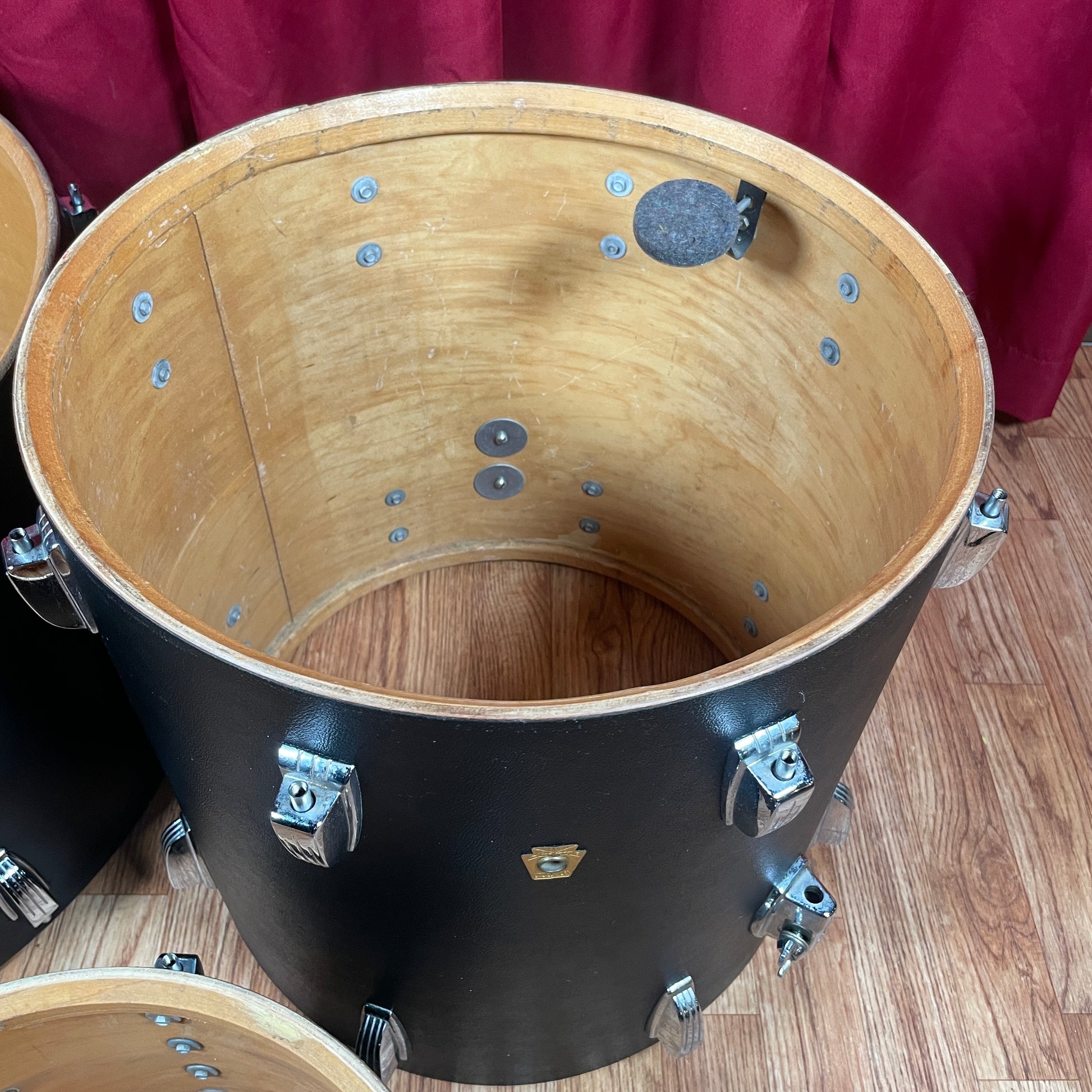 Interior view of the floor tom shell showing the natural maple interior and tom mount hardware