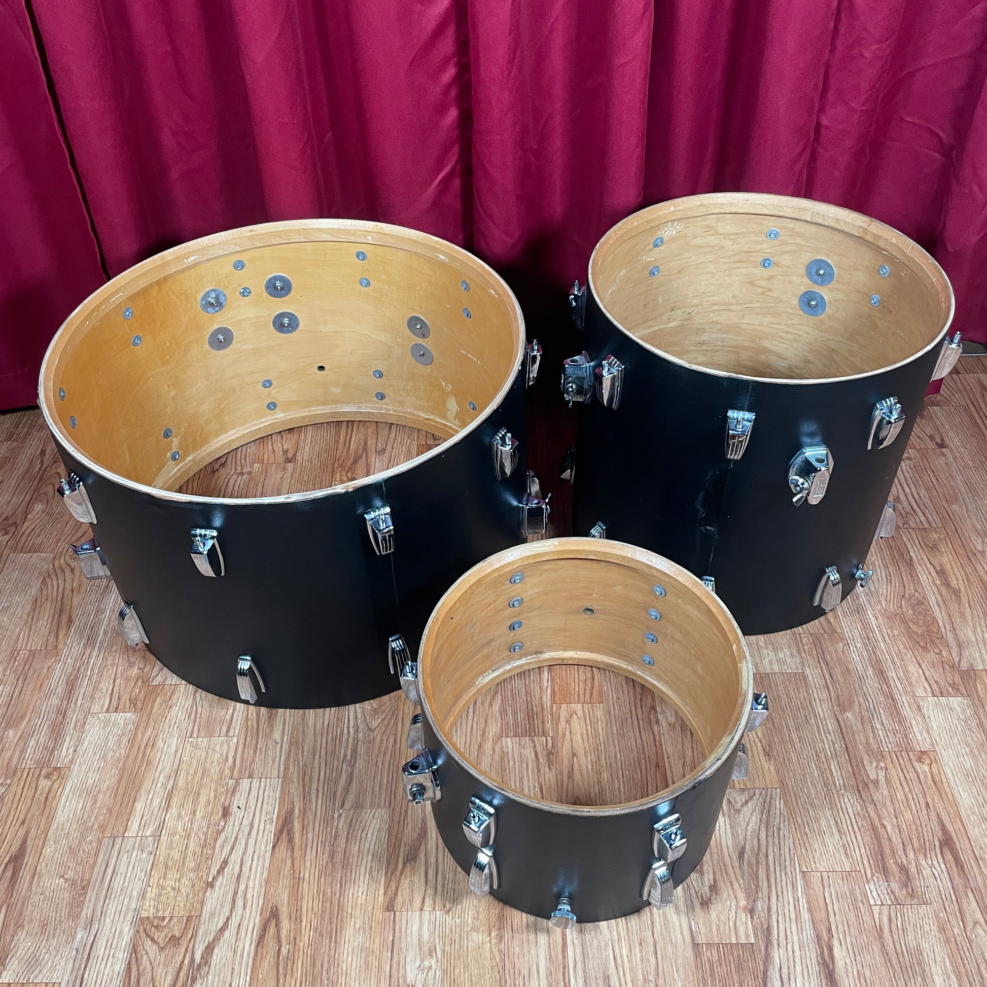 Interior view of the bass drum and floor tom shells side by side, showing the floor tom's mounting bracket