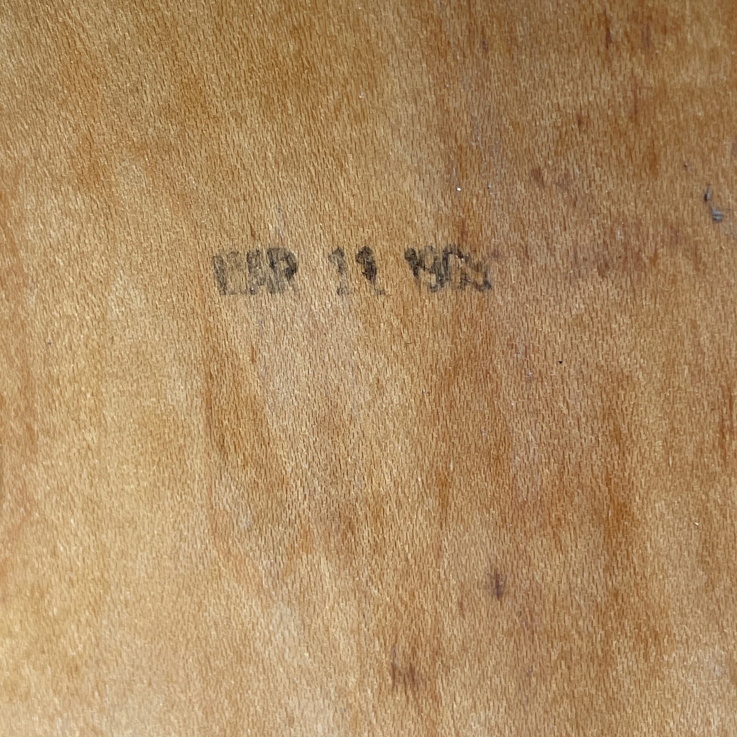 Close-up of a faded ink date stamp inside one of the drum shells