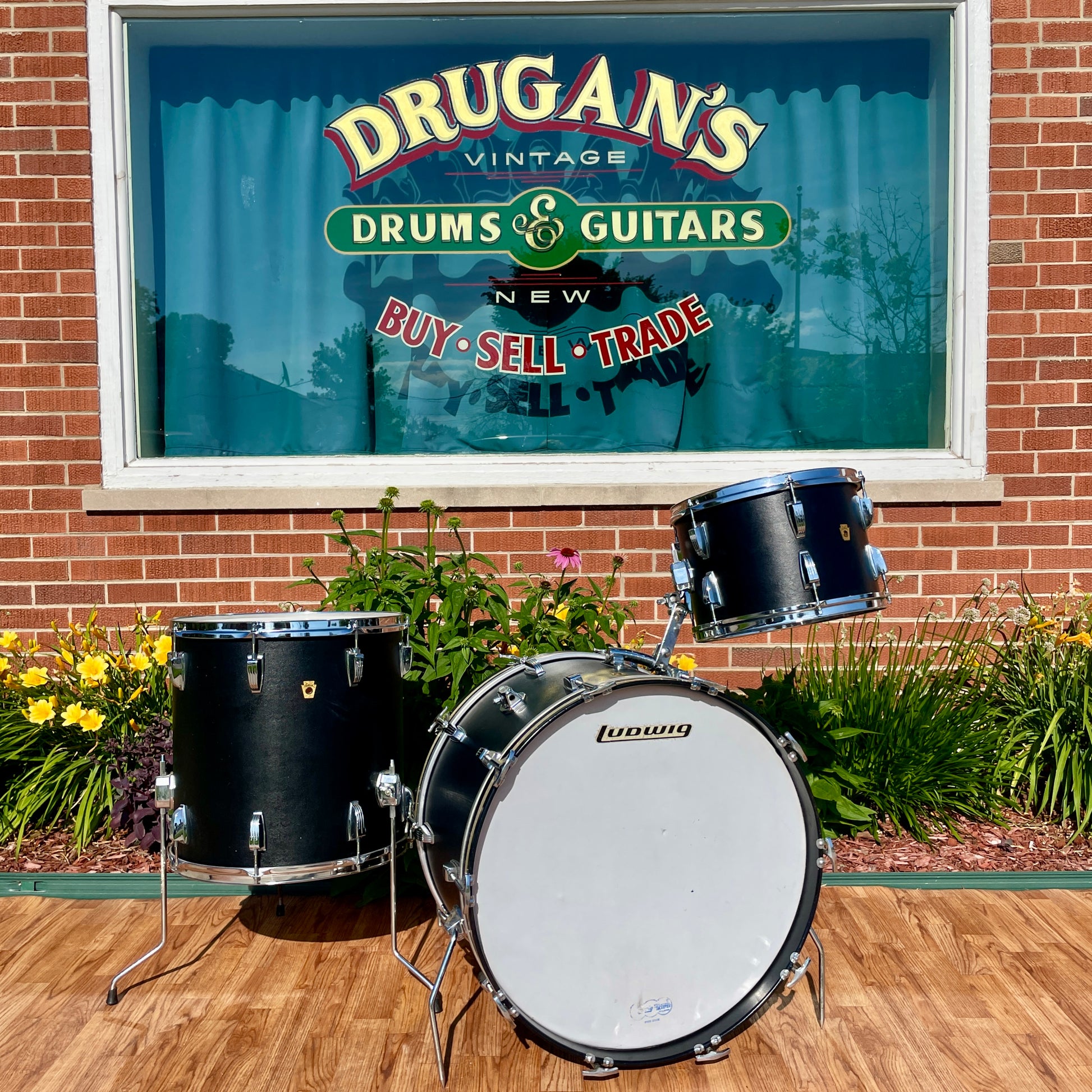 1960s Ludwig Super Classic drum set in Black Panther wrap displayed outside Drugan's Drums and Guitars, showing bass drum, rack tom, and floor tom