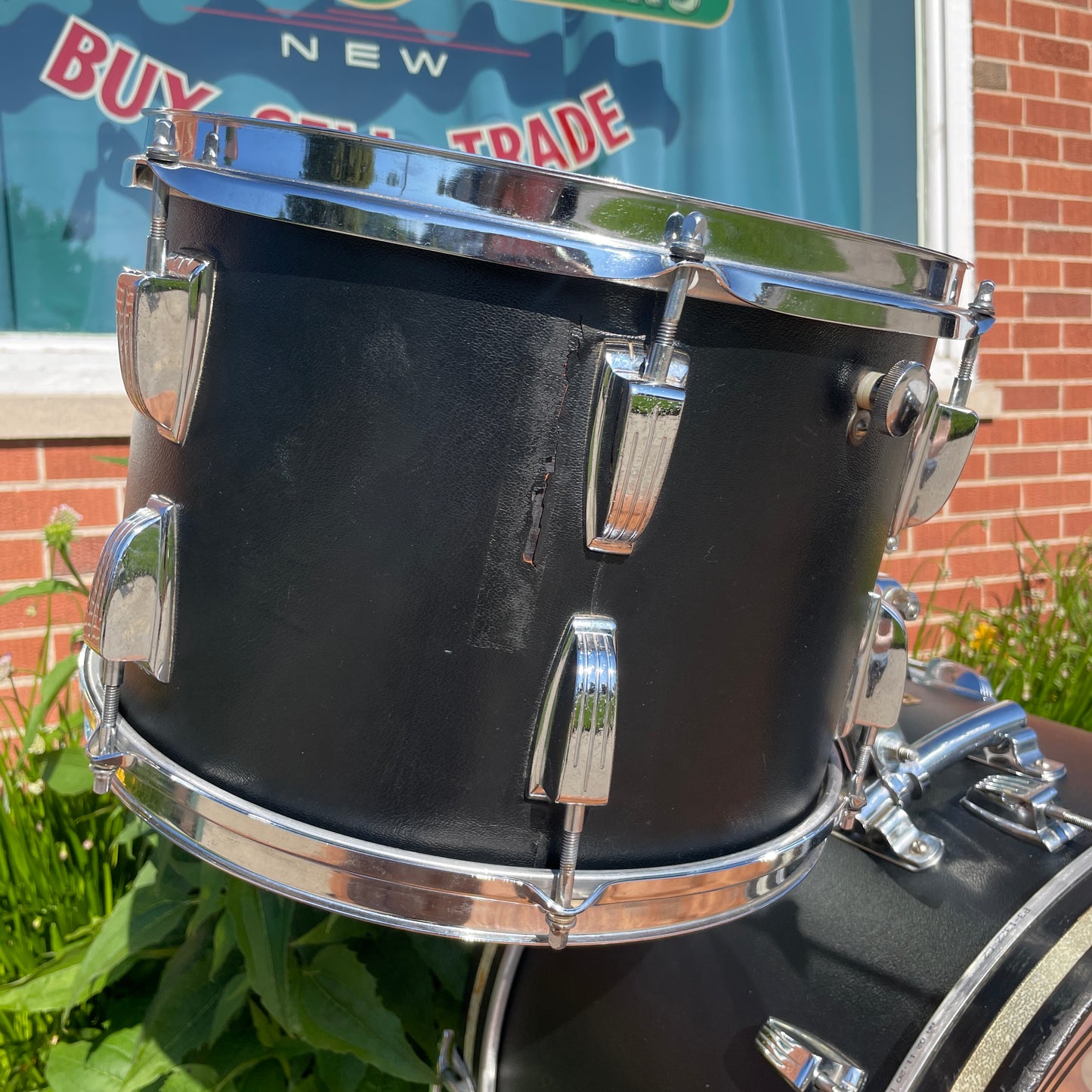 Close-up of the floor tom's cracked wrap seam near the tension lugs